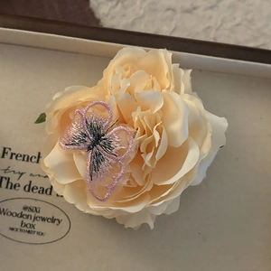 Blue camellia hair clip with delicate purple embroidered butterfly for seaside beach vacations