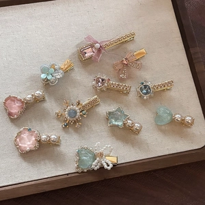 10-piece set of premium pastel hair clips with pearls and floral motifs on gold base