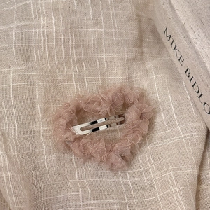 Pince à cheveux cœur en gaze rose élégante avec paillettes dorées sur lin beige doux
