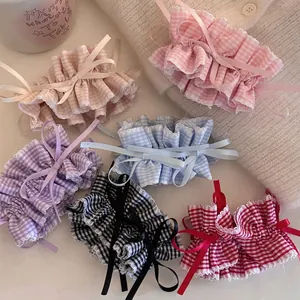 Set of six colorful plaid scrunchies with white lace edges and dainty ribbon bows