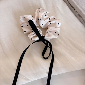 Elegant off-white polka dot scrunchie with long black ribbons for low ponytail hairstyles