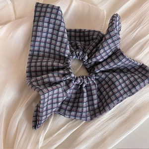 Blue plaid scrunchie hair tie with classic vintage check pattern and ribbon detail