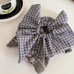 Blue plaid scrunchie with bunny ear bow design for elegant ponytail styling
