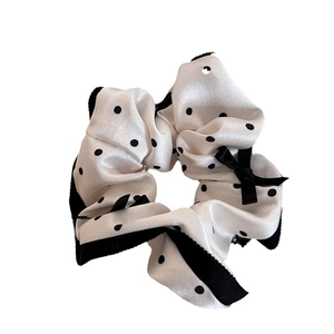 Cream polka dot silk scrunchie with black ribbon bow and lace edge for hair styling