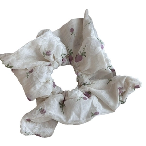 Floral scrunchie with light purple roses on white fabric in a fresh pastoral style