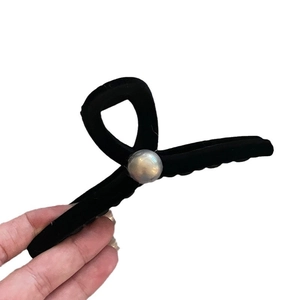 Elegant black velvet hair claw clip with a large grey pearl on a clean white background