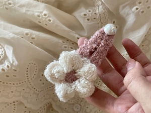 Detalle de pinza para el pelo con flor tejida a mano y elegante detalle de perla blanca