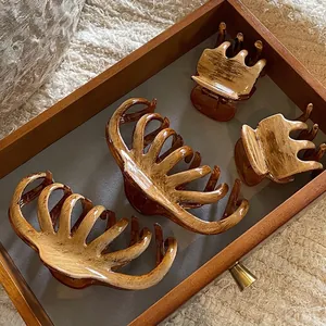 Set of four tortoiseshell hair claws in brown acetate with vintage wood texture pattern