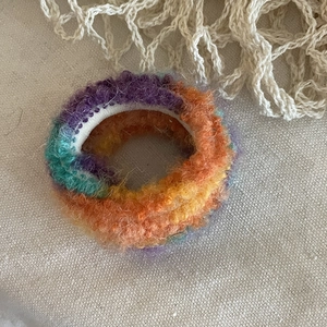 Detailed texture of rainbow mohair hair scrunchie with soft gradient fuzzy material
