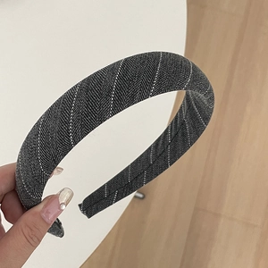 Close-up of gray striped fabric headband with detailed twill weaving texture