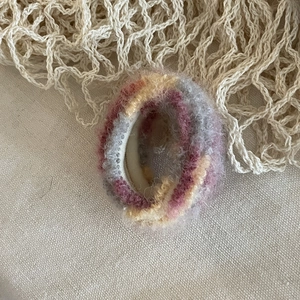 Detail of soft mohair blended scrunchie with pink yellow and grey color gradient