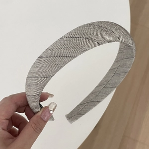 Classic grey plaid headband with premium fabric texture shown in a hand-held display