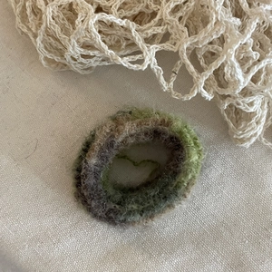 Detailed texture of mohair blend hair tie in green and brown gradient tones