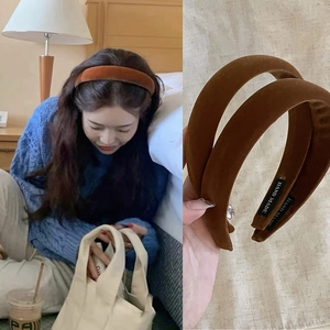 Close-up of caramel velvet headband featuring handmade label and soft padded texture