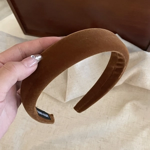Detail of caramel velvet headband showing the thick texture and Hand Made label