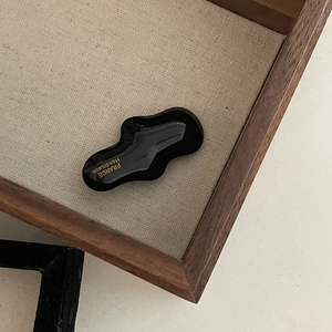 Minimalist black wavy hair clip with gold France Handmade lettering on wooden tray