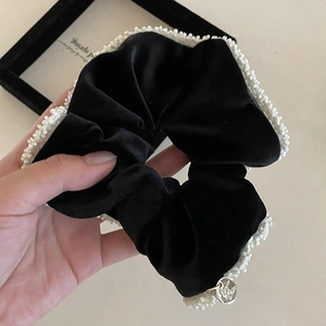 Elegant black velvet scrunchie with white pearl edges and silver metal pendant charm