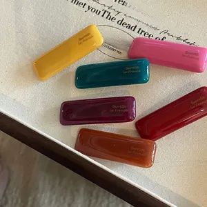 Close-up of colorful resin French barrettes with gloss finish and engraved lettering