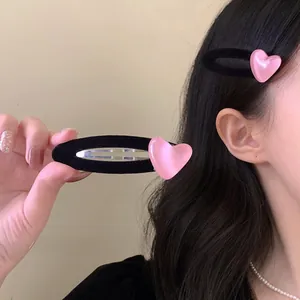Pink jelly heart hair clip with black velvet flocking shown on model for sweet style