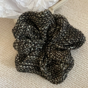 Elegant thick tweed scrunchie with black blue and white woven texture for hair styling