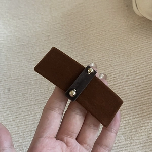 Detailed view of grey velvet hair clip with elegant golden beads for autumn and winter