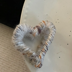 Minimalist knit heart hair claw clip in grey and brown yarn for elegant hairstyles