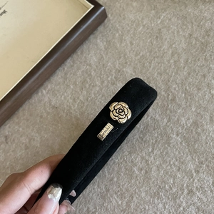 French vintage black velvet headband with gold camellia embellishment and metal logo
