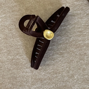 Elegant black flocked hair claw clip with golden metal piece and matte finish for women