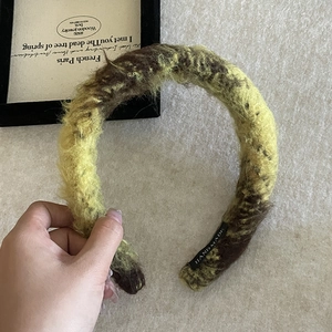 Knitted wool hairband with yellow and brown marble pattern in a wide minimalist style