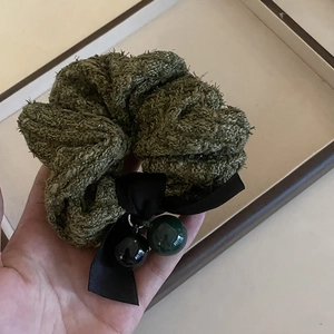 Green knit hair scrunchie with black satin bow and hanging round bead charms