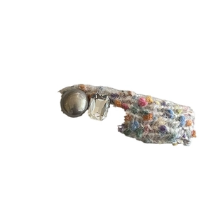 Colorful knitted hair clip with grey pearl and crystal stone on a clean white background