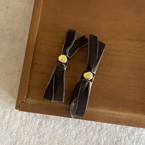 Elegant pair of velvet bow hair clips with gold center buckles for women's hair styling