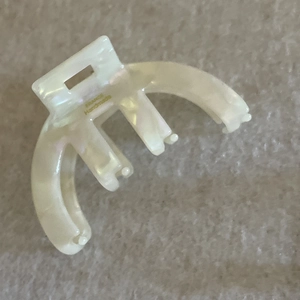 Detail of cream white acetate hair claw clip showing the FRANCE Handmade gold lettering