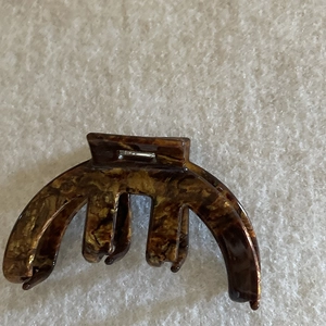 Detailed top view of a French amber tortoiseshell acetate hair claw clip on fabric