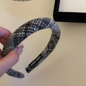 Detailed view of handmade textured thick knit plaid sponge headband in grey mixed tones
