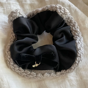 Elegant black satin hair scrunchie with grey knit border and velvet bow detail