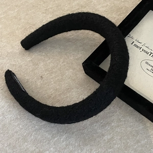 Thick black sponge headband in soft fleece material with a handmade label for women