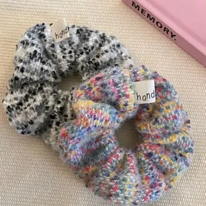 Fuzzy oversized scrunchies in tweed and colorful knit with custom fabric labels