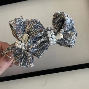 Elegant blue tweed bow hair claw clip with white pearls and luxury metallic details