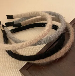 Detailed texture of pleated knitted headbands in beige, grey, black and brown colors