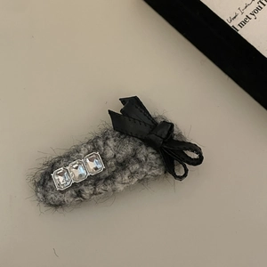 Elegant grey plush hair claw clip featuring sparkling rhinestones and a black satin bow knot
