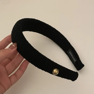 Elegant black tweed headband with asymmetric bow design and gold bead accent