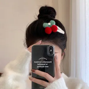 Cute cherry plush hair clip with red pom poms and green leaves on a white metal base
