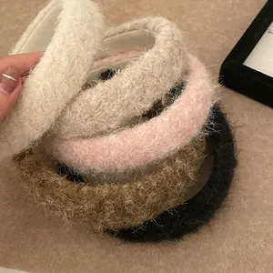 Close-up of soft plush headbands in five warm colors with fluffy lambskin texture