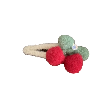 White plush cherry hair clip with red fuzzy balls and green leaf felt decor for women