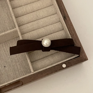 French style suede bow hair clip with large pearl accent in a wooden jewelry box