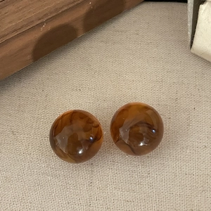 Vintage amber marbled resin stud earrings with a polished round finish for women