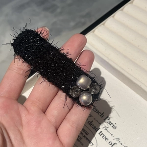 Elegant black velvet hair clip with grey crystal beads and metallic fabric finish