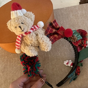 Detail of Christmas headband with plush bear, plaid bow and festive ornaments
