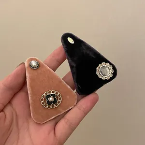 Detail of vintage velvet hair clips with heavy embroidery, pearls and rhinestones